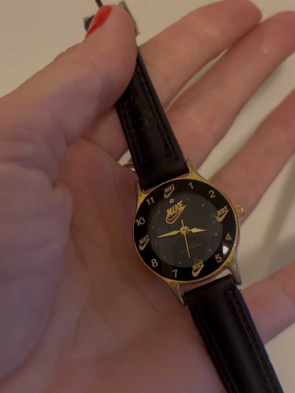 Nike Black Dial Leather Strap Watch with Gold Accents
